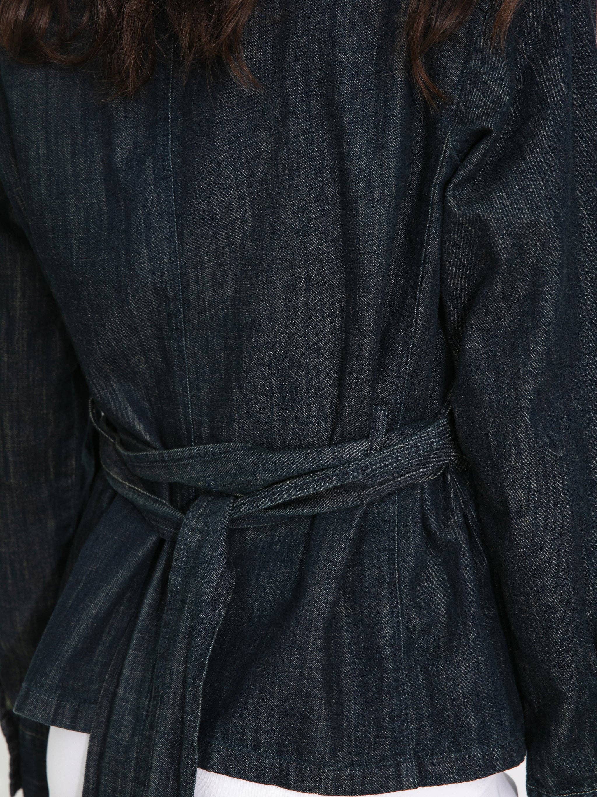 Dark denim jacket with a belt worn by a person