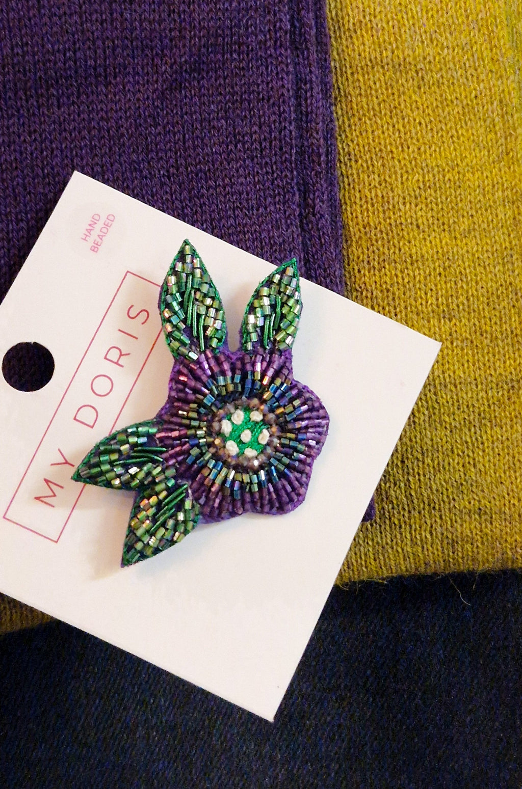 Decorative brooch on a card with a colorful background