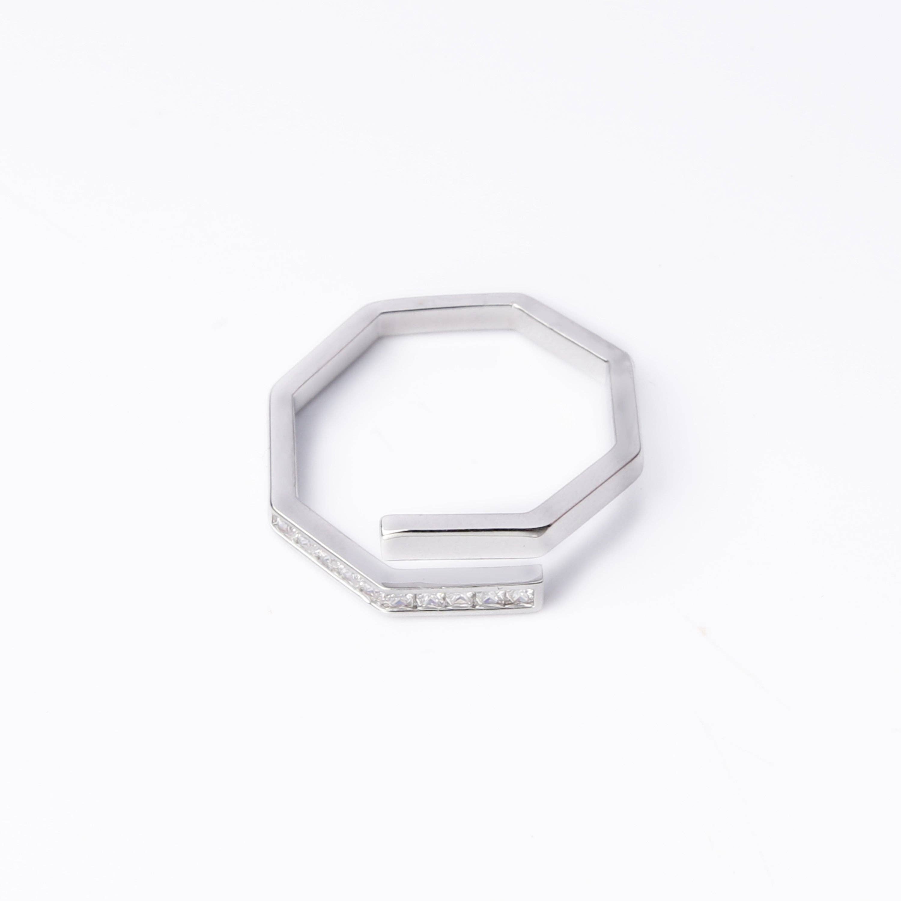 Silver hexagonal ring with small stones on a white background