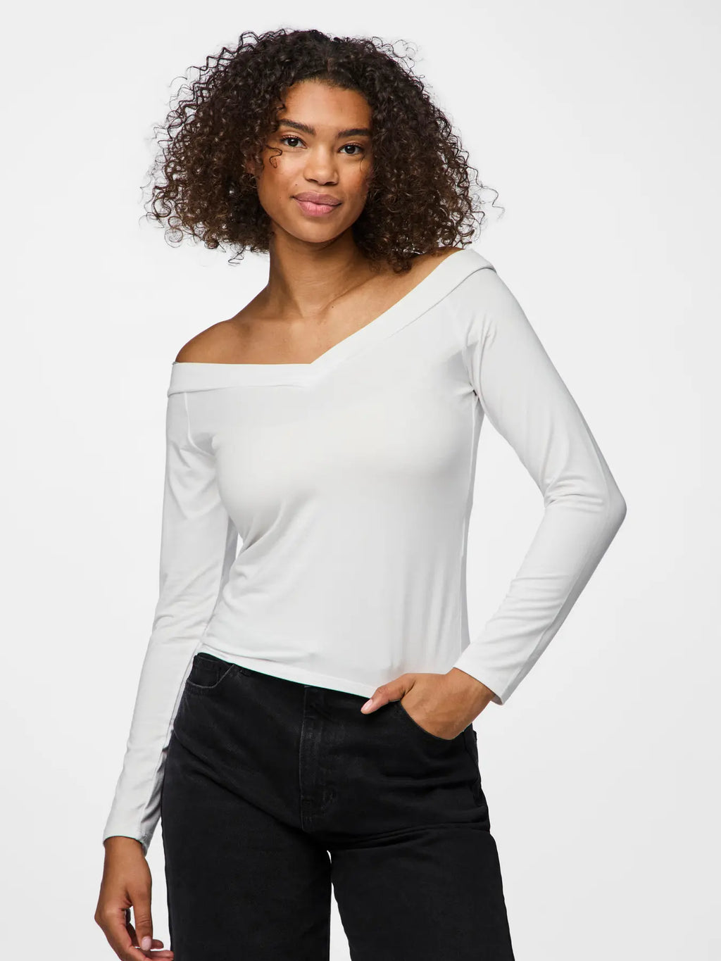 Woman wearing a white off-shoulder long-sleeve top and black pants on a white background