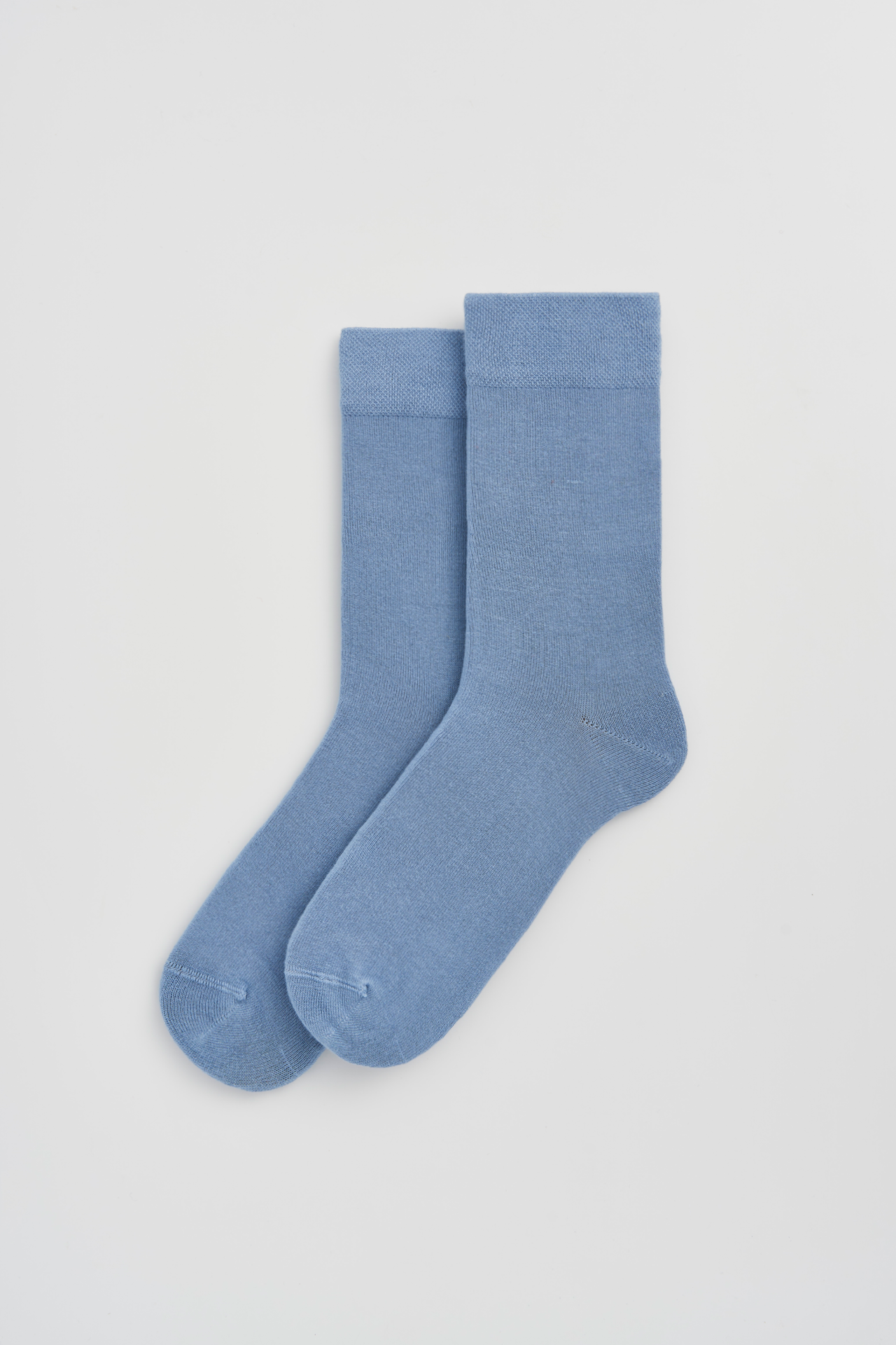 Pair of light blue socks on a white background